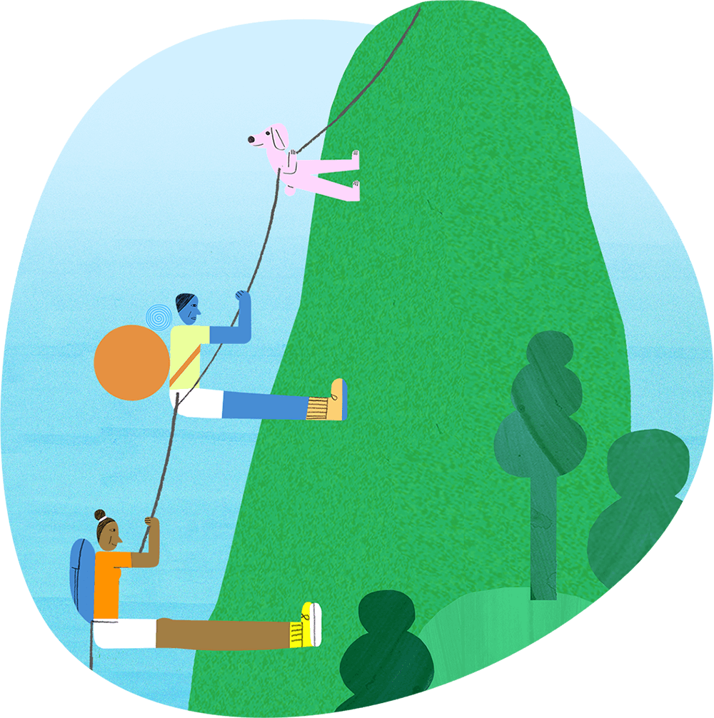 Two people and a dog climbing a steep hill